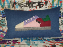 Load image into Gallery viewer, Handmade trainer cushion, rectangular bolster shape with real laces trim on a blue denim base. Approximately 12" x 20" (30cm x 50cm) with a zip opening. Comes with a polycotton cushion inner.