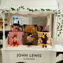 Load image into Gallery viewer, Hazeldee Home Handmade character kid's cushion with trim and legs that extend from the body of the cushion. Aztec Base with leopard and black outfit and matching coral bow. Approximately 16" x 16" (40cm x 40cm) with a centre back zip. Comes with a polycotton cushion inner. Each Hazeldee Home Munchkin Character Cushion comes with a numbered Certificate of Authenticity.