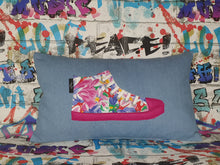 Load image into Gallery viewer, Hazeldee Home Handmade hi-top trainer cushion, rectangular bolster shape with real laces trim on a blue denim base. A great conversational trainer cushion for kids and grown ups alike! Bring some fun and colour into your space with this handmade cushion with a hi-top trainer with laces detail! Bold floral print hi-top sneaker trainer cushion with contrast fuchsia pink detail. Approximately 12" x 20" (30cm x 50cm) with a zip opening. Comes with a polycotton cushion inner.