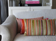 Load image into Gallery viewer, Hazeldee Home Handmade multi stripe lumbar rectangle cushion using a luxurious stripe velvet design for the front with oatmeal, rust, cream, cardamom and hints of lilac and purple. The reverse features an Italian velvet fabric in a rich sumptuous rust colour.  Together these colours beautifully depict colours of Marrakesh and add bold colour to any room.  Approximately 12" x 20" (30cm x 50cm) with a concealed zip.  Comes with a polycotton lined cushion inner.
