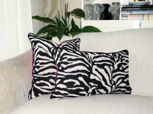 Load image into Gallery viewer, Hazeldee Home Limited Edition Handmade double-sided cushion with a bold monochrome cotton blend jacquard zebra design on one size and a vibrant fuchsia pink Italian cotton velvet on the reverse edged with a black cotton trim.     This cushion is fully reversible so you essentially get two looks in one!    Approximately 12" x 20" (30cm x 50cm) rectangle with a concealed zip.   Comes with a polycotton lined cushion inner.