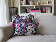 Load image into Gallery viewer, Hazeldee Home Handmade Navy Watercolour floral print cotton cushion with our trademark contrast silky double tassels detailing; a new addition to the Hazeldee Botanical Collection.     Aylesbury bold watercolour floral print with a Navy base adds a lovely touch of nature to any room.  The scattered floral flowers and blooms are rich in colour and add the feeling of spring to any space.   Approximately 12" x 20" (30cm x 50cm) with a concealed zip.