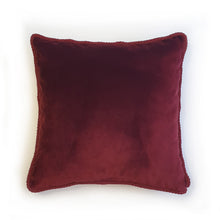 Load image into Gallery viewer, Hazeldee Home Handmade double-sided cushion with a fresh botanical green based wild flower floral print on one side and rich Italian velvet in burgundy on the reverse, edged with a contrasting burgundy intricate interwoven rope.   Inspired by European botanical gardens, this floral print features playfully bold wild flowers with other wildlife in the form of whimsical butterflies berries and tree branches detailed within the print.  A truly enchanting design.