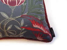 Load image into Gallery viewer, Hazeldee Home Handmade double-sided cushion with a fresh botanical green based wild flower floral print on one side and rich Italian velvet in burgundy on the reverse, edged with a contrasting burgundy intricate interwoven rope.   Inspired by European botanical gardens, this floral print features playfully bold wild flowers with other wildlife in the form of whimsical butterflies berries and tree branches detailed within the print.  A truly enchanting design.