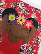 Load image into Gallery viewer, Frida Kahlo cushion inspired by artist Frida Kahlo with trim and legs that extend from the body of the cushion.    Designed and handmade by Hazeldee Home, these cushions are a bundle of fun! Each Cushion is one-of-a-kind with bright backgrounds, different skin tones and hairstyles with flowers to match!   Frida Kahlo was a Mexican painter known for self-portraits and use of bright colour.   Approximately 16" x 16" (40cm x 40cm) with a centre back zip. Comes with a polycotton cushion inner.