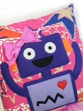 Load image into Gallery viewer, Hazeldee Home Handmade Robot Munchkin Cushion with trim detail and legs that extend from the body of the cushion.    Designed and handmade by Hazeldee Home, these cushions are a bundle of fun! Each Cushion is one-of-a-kind with bright backgrounds and bold contrasting robot character detail!   Approximately 16" x 16" (40cm x 40cm) with a centre back zip. Comes with a polycotton cushion inner.    Each Hazeldee Home Munchkin Character Cushion comes with a numbered Certificate of Authenticity.