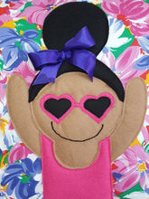 Load image into Gallery viewer, Handmade Munchkin cushion with heart sunglasses with trim and legs and tutu skirt that extend from the body of the cushion. Designed and handmade by Hazeldee Home, these cushions are a bundle of fun! Each Cushion is one-of-a-kind with bright backgrounds, different skin tones and hairstyles with bows to match! Approximately 16" x 16" (40cm x 40cm) with a centre back zip. Comes with a polycotton cushion inner. Each Hazeldee Home Munchkin Cushion comes with a numbered Certificate of Authenticity.