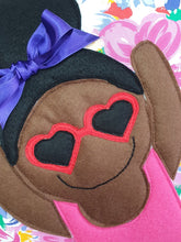 Load image into Gallery viewer, Handmade Munchkin cushion with heart sunglasses with trim and legs and tutu skirt that extend from the body of the cushion. Designed and handmade by Hazeldee Home, these cushions are a bundle of fun! Each Cushion is one-of-a-kind with bright backgrounds, different skin tones and hairstyles with bows to match! Approximately 16" x 16" (40cm x 40cm) with a centre back zip. Comes with a polycotton cushion inner. Each Hazeldee Home Munchkin Cushion comes with a numbered Certificate of Authenticity.