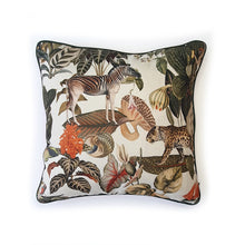 Load image into Gallery viewer, Hazeldee Home Limited Edition Handmade double-sided cushion with an intricate animal design inspired by the African Savannas featuring zebras, leopards, cheetahs, monkeys and more paired back with bold green plants and flowers on a neutral cream background.  The reverse features a vibrant coral cotton velvet and forest green cotton piping trim.     This cushion is fully reversible so you get two looks in one!    Approximately 18" x 18" (45cm x 45cm) square with a concealed zip.