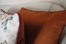 Load image into Gallery viewer, Hazeldee Home handmade double-sided cushion featuring decadent silky geometric jacquard with tones of paprika chilli with contrasting silky trim.  Approximately 18" x 18" (45cm x 45cm) square with a concealed zip.
