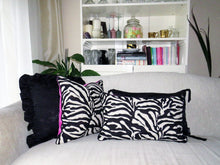 Load image into Gallery viewer, Hazeldee Home Limited Edition Handmade double-sided cushion with a bold monochrome cotton blend jacquard zebra design on one size and a vibrant fuchsia pink Italian cotton velvet on the reverse edged with a black cotton trim.     This cushion is fully reversible so you essentially get two looks in one!    Approximately 12" x 20" (30cm x 50cm) rectangle with a concealed zip.   Comes with a polycotton lined cushion inner.