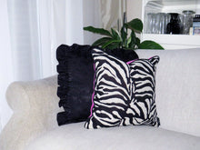 Load image into Gallery viewer, Hazeldee Home Limited Edition Handmade double-sided cushion with a bold monochrome cotton blend jacquard zebra design on one size and a vibrant fuchsia pink Italian cotton velvet on the reverse edged with a black cotton trim.     This cushion is fully reversible so you essentially get two looks in one!    Approximately 12" x 20" (30cm x 50cm) rectangle with a concealed zip.   Comes with a polycotton lined cushion inner.