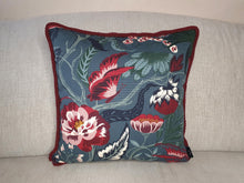 Load image into Gallery viewer, Hazeldee Home Handmade double-sided cushion with a fresh botanical green based wild flower floral print on one side and rich Italian velvet in burgundy on the reverse, edged with a contrasting burgundy intricate interwoven rope.   Inspired by European botanical gardens, this floral print features playfully bold wild flowers with other wildlife in the form of whimsical butterflies berries and tree branches detailed within the print.  A truly enchanting design.