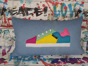 Hazeldee Home Handmade bold colour-block trainer cushion, rectangular bolster shape with real laces trim on a blue denim base.  A great conversational trainer cushion for kids and grown ups alike!  Bring some fun and colour into your space with this handmade cushion with a trainer with laces detail!  Colour-block sneaker trainer cushion with Hazeldee Home label detail.  Approximately 12" x 20" (30cm x 50cm) with a zip opening.   Comes with a polycotton cushion inner.