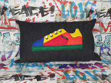 Load image into Gallery viewer, Hazeldee Home Handmade bold colour-block trainer cushion, rectangular bolster shape with real laces trim on a black denim base.  A great conversational trainer cushion for kids and grown ups alike!  Bring some fun and colour into your space with this handmade cushion with a trainer with laces detail!  colour-block sneaker trainer cushion with Hazeldee Home label detail.  Approximately 12&quot; x 20&quot; (30cm x 50cm) with a zip opening.   Comes with a polycotton cushion inner.
