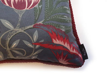 Load image into Gallery viewer, Hazeldee Home Handmade double-sided cushion with a fresh botanical green based wild flower floral print on one side and rich Italian velvet in burgundy on the reverse, edged with a contrasting burgundy intricate interwoven rope.   Inspired by European botanical gardens, this floral print features playfully bold wild flowers with other wildlife in the form of whimsical butterflies berries and tree branches detailed within the print.  A truly enchanting design.
