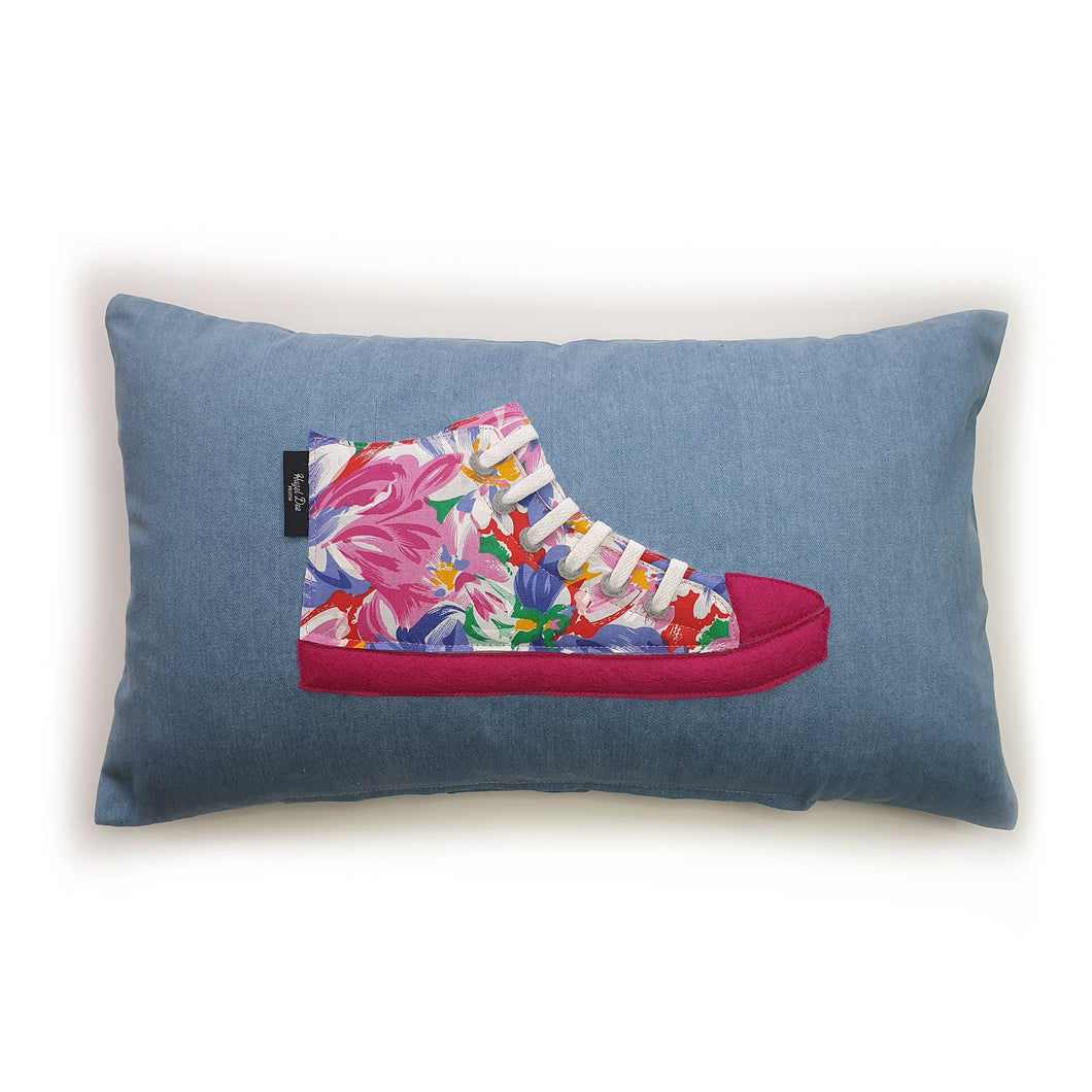 Hazeldee Home Handmade hi-top trainer cushion, rectangular bolster shape with real laces trim on a blue denim base.  A great conversational trainer cushion for kids and grown ups alike!  Bring some fun and colour into your space with this handmade cushion with a hi-top trainer with laces detail!  Bold floral print hi-top sneaker trainer cushion with contrast fuchsia pink detail.  Approximately 12