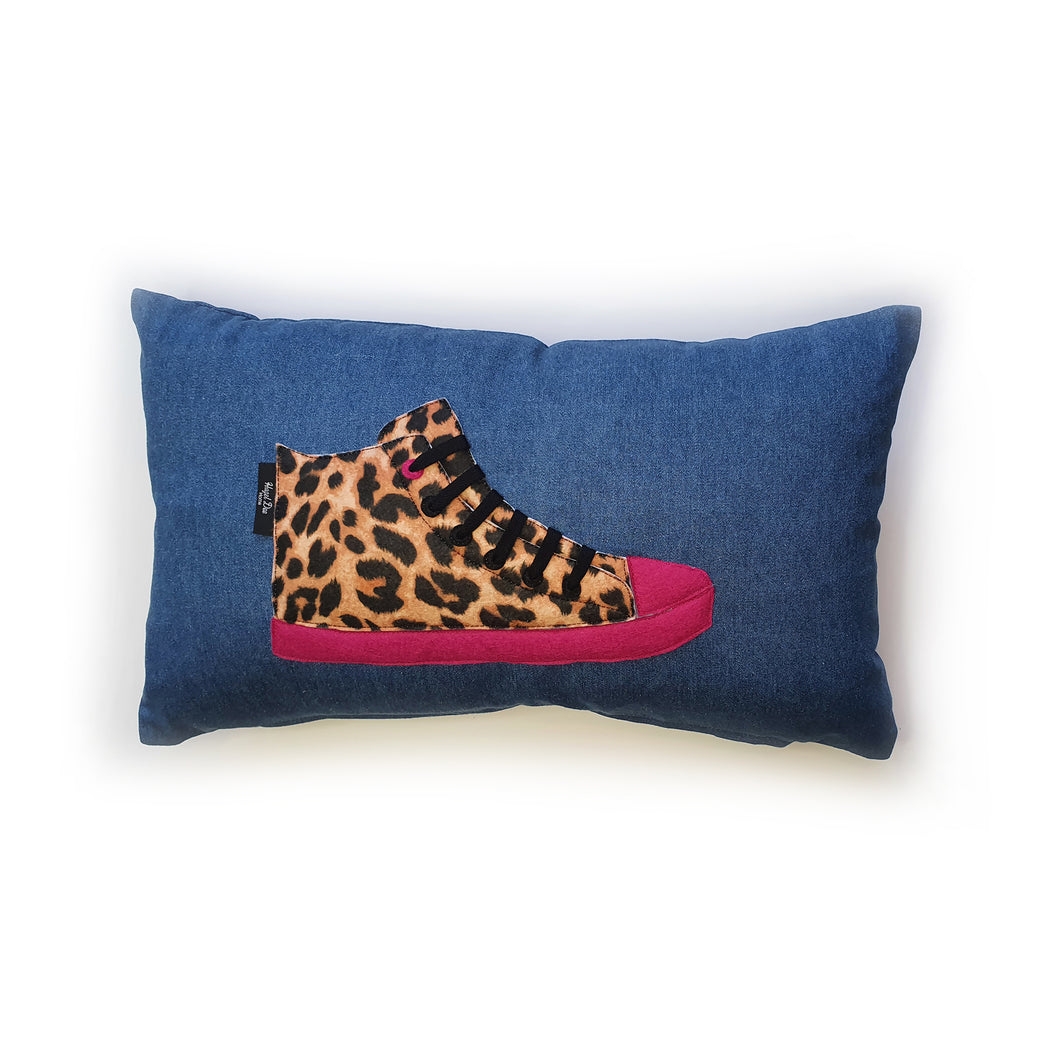 Hazeldee Home Handmade hi-top trainer cushion, rectangular bolster shape with real laces trim on a blue denim base.  A great conversational trainer cushion for kids and grown ups alike!  Bring some fun and colour into your space with this handmade cushion with a hi-top trainer with laces detail!  Natural Leopard print hi-top sneaker trainer cushion with contrast bright pink detail.  Approximately 12