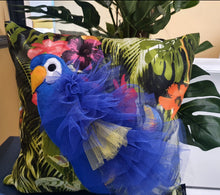 Load image into Gallery viewer, Handmade Parrot bird illustration character cushion with 3D feather effect trim.      A great conversational parrot cushion for kids and grown ups alike!  Bring some fun and colour into your space with this handmade cushion with a bold blue parrot cushion with plume of blue and yellow feather-like trim with a tropical leaf fabric base!  A one-of-a-kind Hazeldee Home design.  Approximately 16&quot; x 16&quot; (40cm x 40cm) with a centre back zip. Comes with a polycotton cushion inner.  
