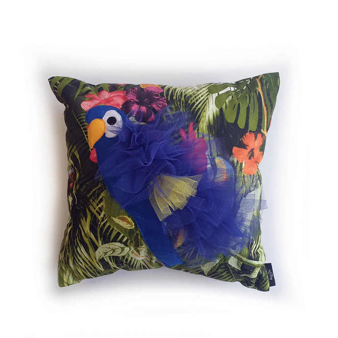 Handmade Parrot bird illustration character cushion with 3D feather effect trim. A great conversational parrot cushion for kids and grown ups alike! Bring some fun and colour into your space with this handmade cushion with a bold blue parrot cushion with plume of blue and yellow feather-like trim with a tropical leaf fabric base! A one-of-a-kind Hazeldee Home design. Approximately 16