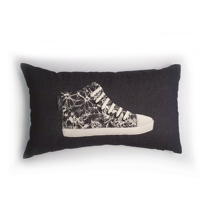 Handmade hi-top trainer cushion, rectangular bolster shape with real laces trim on a black denim base.  A great conversational trainer cushion for kids and grown ups alike!  Bring some fun and colour into your space with this handmade cushion with a hi-top trainer with laces detail!  Black and cream monochrome floral print hi-top sneaker trainer cushion with cream laces and contrast detail.