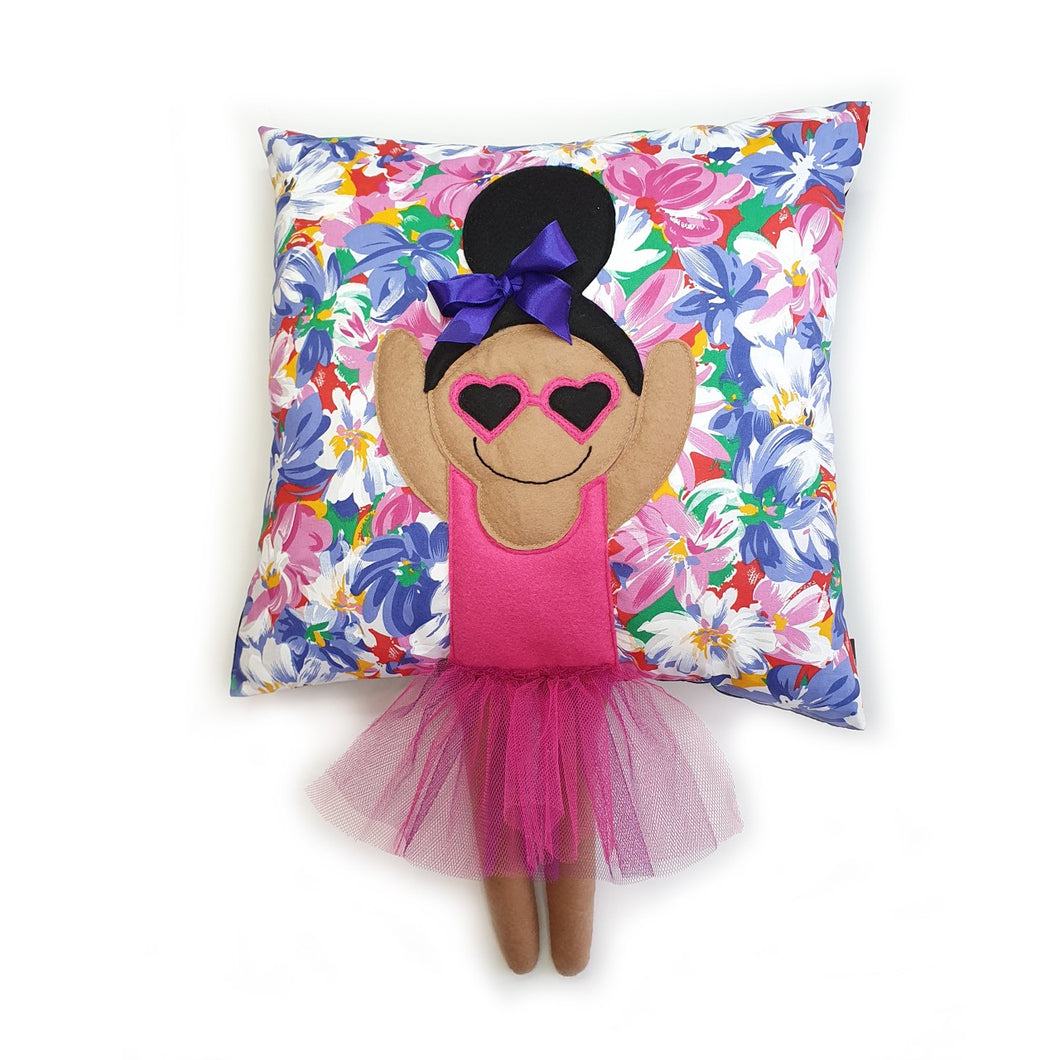 Handmade Munchkin cushion with heart sunglasses with trim and legs and tutu skirt that extend from the body of the cushion. Designed and handmade by Hazeldee Home, these cushions are a bundle of fun! Each Cushion is one-of-a-kind with bright backgrounds, different skin tones and hairstyles with bows to match! Approximately 16