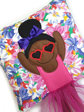 Load image into Gallery viewer, Handmade Munchkin cushion with heart sunglasses with trim and legs and tutu skirt that extend from the body of the cushion. Designed and handmade by Hazeldee Home, these cushions are a bundle of fun! Each Cushion is one-of-a-kind with bright backgrounds, different skin tones and hairstyles with bows to match! Approximately 16&quot; x 16&quot; (40cm x 40cm) with a centre back zip. Comes with a polycotton cushion inner. Each Hazeldee Home Munchkin Cushion comes with a numbered Certificate of Authenticity. 
