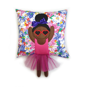 Handmade Munchkin cushion with heart sunglasses with trim and legs and tutu skirt that extend from the body of the cushion. Designed and handmade by Hazeldee Home, these cushions are a bundle of fun! Each Cushion is one-of-a-kind with bright backgrounds, different skin tones and hairstyles with bows to match! Approximately 16" x 16" (40cm x 40cm) with a centre back zip. Comes with a polycotton cushion inner. Each Hazeldee Home Munchkin Cushion comes with a numbered Certificate of Authenticity. 