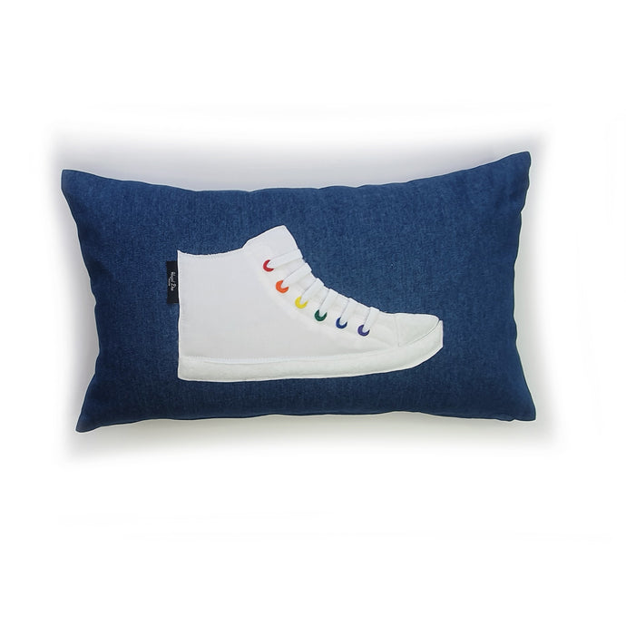 Hazeldee Home Handmade hi-top trainer cushion with real laces trim on a blue denim base.  We kept this version box fresh white and added colourful rainbow rivet detail for subtle colour and fun.  A great conversational trainer cushion for kids and grown ups alike!  Bring some fun and colour into your space with this handmade cushion with a hi-top trainer with laces detail!  White hi-top sneaker trainer cushion with rainbow coloured eyelets.  Approximately 12