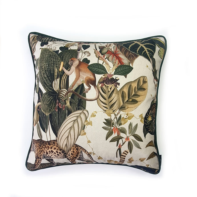 Hazeldee Home Limited Edition Handmade double-sided cushion with an intricate animal design inspired by the African Savannas featuring zebras, leopards, cheetahs, monkeys and more paired back with bold green plants and flowers on a neutral cream background.   The reverse features a tonal cream cotton velvet and forest green cotton piping trim.   This cushion is fully reversible so you get two looks in one!    Approximately 16