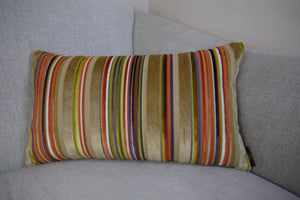Hazeldee Home Handmade multi stripe lumbar rectangle cushion using a luxurious stripe velvet design for the front with oatmeal, rust, cream, cardamom and hints of lilac and purple. The reverse features an Italian velvet fabric in a rich sumptuous rust colour.  Together these colours beautifully depict colours of Marrakesh and add bold colour to any room.  Approximately 12" x 20" (30cm x 50cm) with a concealed zip.  Comes with a polycotton lined cushion inner.