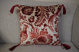 Hazeldee Home Handmade double-sided square velvet cushion with a Dutch inspired design in Regal Red from the Linwood Archive- a cream velvet with rust pheasant and filigree design print one side and Italian rust velvet on the reverse with bold contrast silky tassels.  Approximately 16" x 16" (40cm x 40cm) square with a concealed zip.  Comes with a polycotton lined cushion inner.