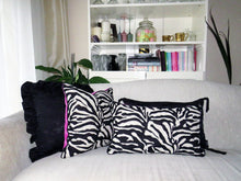Load image into Gallery viewer, Hazeldee Home Limited Edition Handmade double-sided cushion with a bold monochrome cotton blend jacquard zebra design on one size and a vibrant fuchsia pink Italian cotton velvet on the reverse edged with a black cotton trim.     This cushion is fully reversible so you essentially get two looks in one!    Approximately 12&quot; x 20&quot; (30cm x 50cm) rectangle with a concealed zip.   Comes with a polycotton lined cushion inner.
