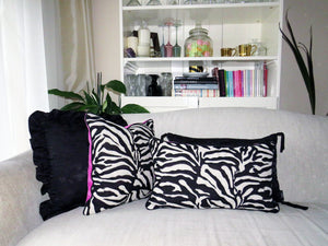 Hazeldee Home Limited Edition Handmade double-sided cushion with a bold monochrome cotton blend jacquard zebra design on one size and a vibrant fuchsia pink Italian cotton velvet on the reverse edged with a black cotton trim.     This cushion is fully reversible so you essentially get two looks in one!    Approximately 12" x 20" (30cm x 50cm) rectangle with a concealed zip.   Comes with a polycotton lined cushion inner.